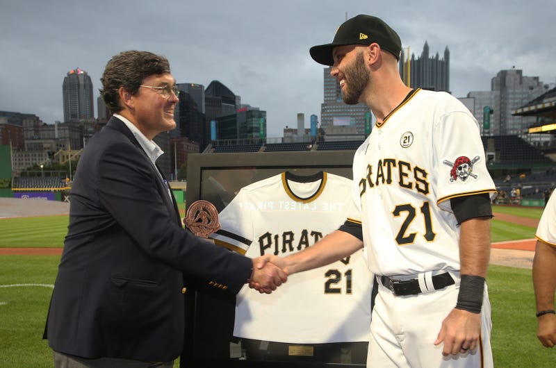 Pittsburgh Pirates chairman Robert Nutting (left) presents catcher Jacob Stallings (58)