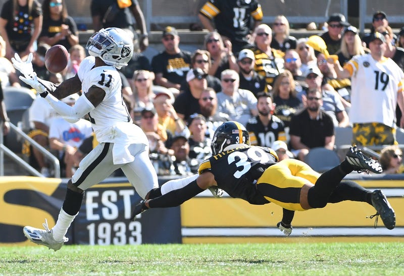 Las Vegas Raiders wide receiver Henry Ruggs III catches a pass for a 61 yard touchdown as Pittsburgh Steelers safety Minkah Fitzpatrick provides defense