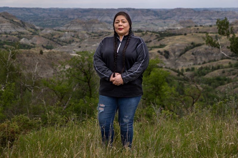 MHA Drug Enforcement special agent, Dawn White, stands in front of one of her favorite parts of North Dakota, the Badlands area south of the Fort Berthold Reservation. White is an Army veteran who grew up on the Fort Berthold Reservation and worked as a Sgt. for the Tribal Police before joining the specialized drug task force based in Parshall, North Dakota. June 25, 2021. As 9633 Powwow Police Northdakota Pipeline451