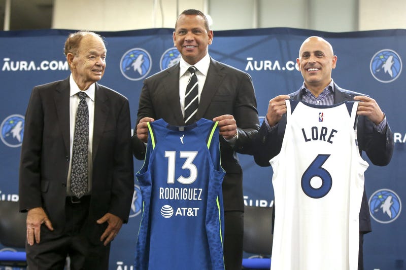 Current owner Glen Taylor and limited partners and alt-governors for the Minnesota Timberwolves Alex Rodriguez and Mark Lore hold up jerseys after answering questions at a press conference at media day in 2021.