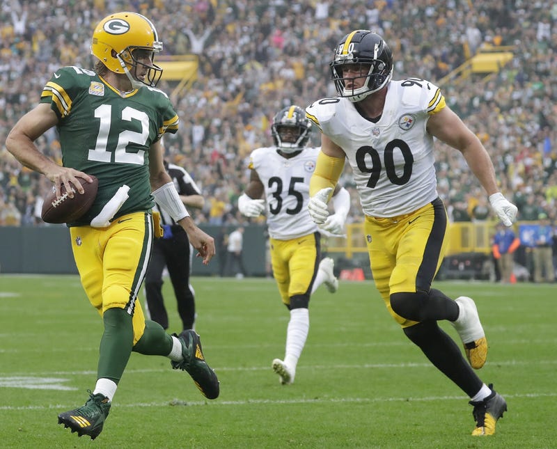 Aaron Rodgers runs past TJ Watt into end zone