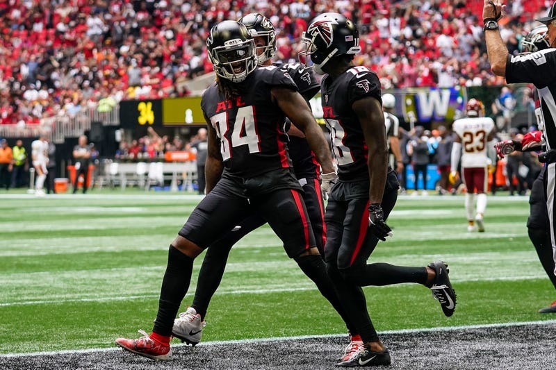 Oct 3, 2021; Atlanta, Georgia, USA; Atlanta Falcons running back Cordarrelle Patterson (84) reacts with wide receiver Calvin Ridley (18) after catching a touchdown pass over Washington Football Team cornerback Kendall Fuller (29) during the second half at Mercedes-Benz Stadium.