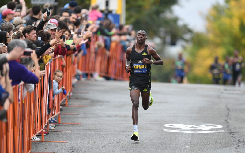 Men's winner Benson Kipruto is cheered by the crowd