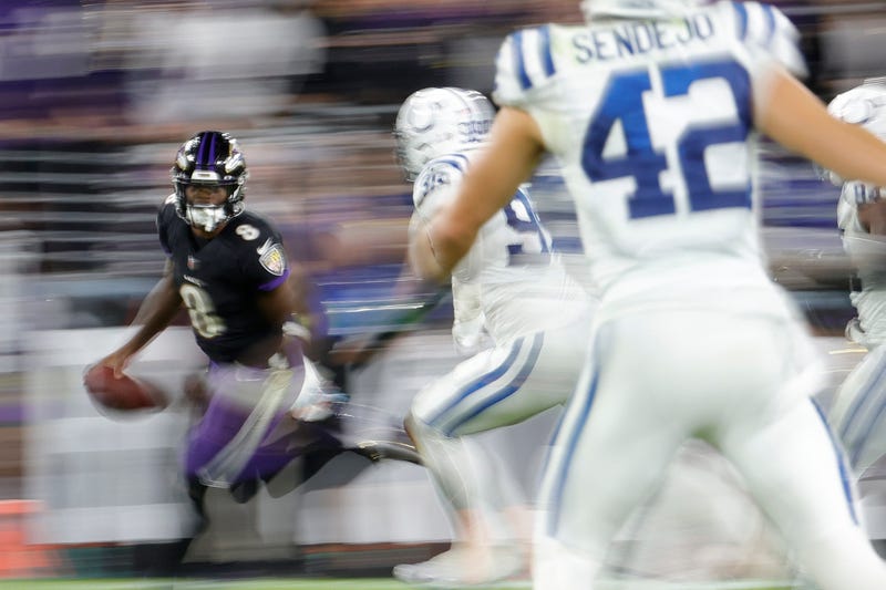 Lamar Jackson runs from Colts defenders