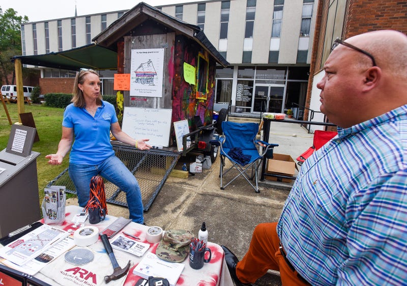 Rev. Lisa Pierce talks with Smiths Station Mayor Bubba Copeland beside the small shack she lives in for a week as a fundraiser for the Alabama Rural Ministry in Auburn, Al., on Tuesday October 12, 2021. Rural04