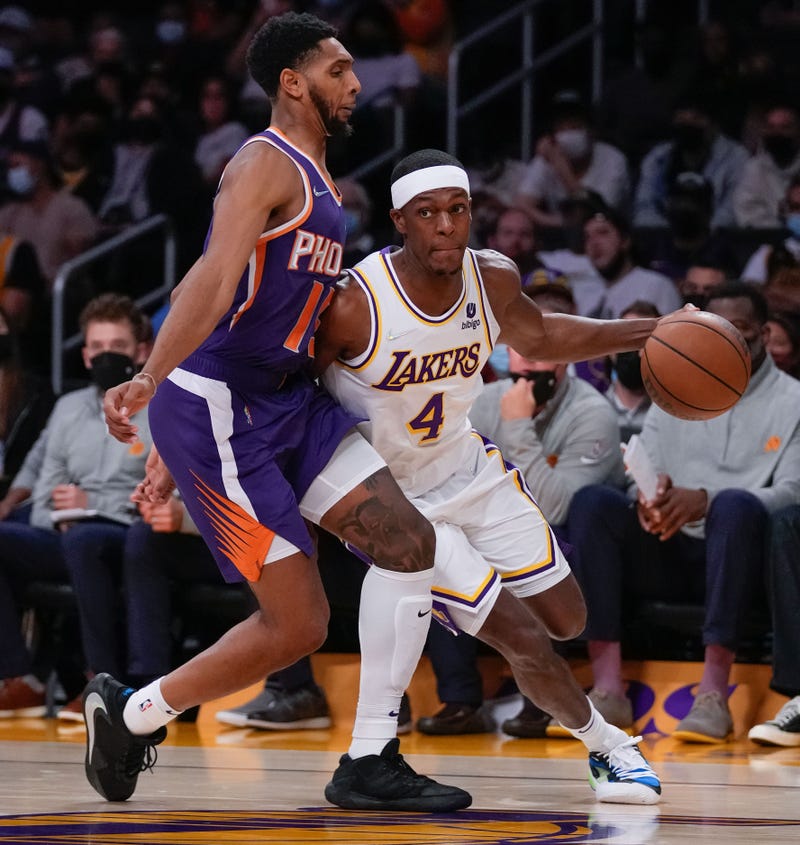 Oct 10, 2021; Los Angeles, California, USA; Los Angeles Lakers guard Rajon Rondo (4) dribbles down the baseline guarded by Phoenix Suns guard Cameron Payne (15) during the first half at Staples Center.