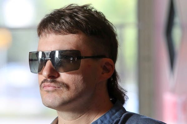 Man with a mullet haircut and sunglasses
