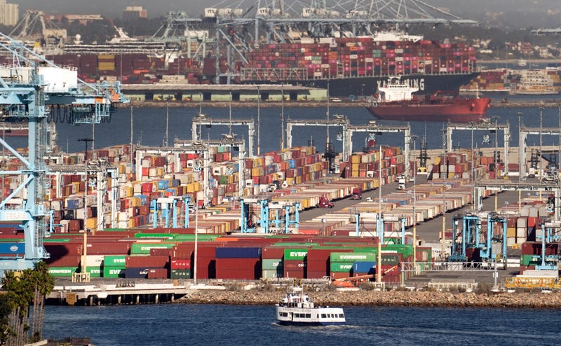 Cargo containers wait to be transported after being offloaded at the Port of Los Angeles, Oct 16, 2021 in San Pedro, California