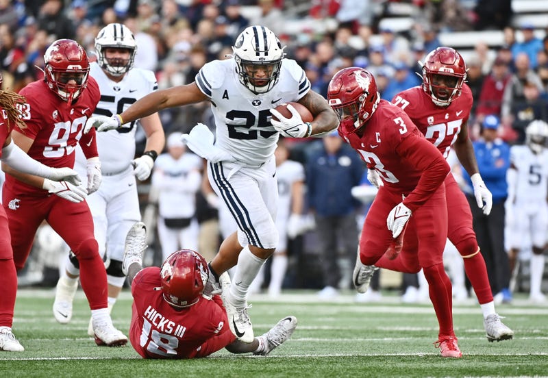 Brigham Young Cougars running back Tyler Allgeier (25) carries the ball against Washington State Cougars defensive back George Hicks III (18) in the second half at Gesa Field at Martin Stadium. BYU won 21-19.