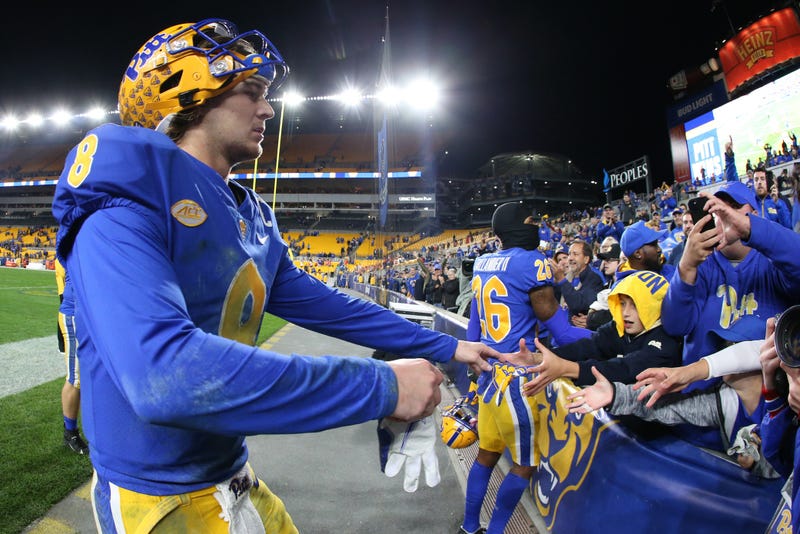Kenny Pickett (8) gives his gloves to a fan after defeating the Clemson Tigers