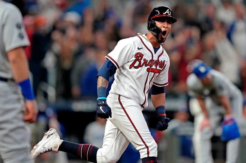 Oct 23, 2021; Cumberland, Georgia, USA; Atlanta Braves left fielder Eddie Rosario (8) hits a three run home run during the fourth inning against the Los Angeles Dodgers in game six of the 2021 NLCS at Truist Park. 