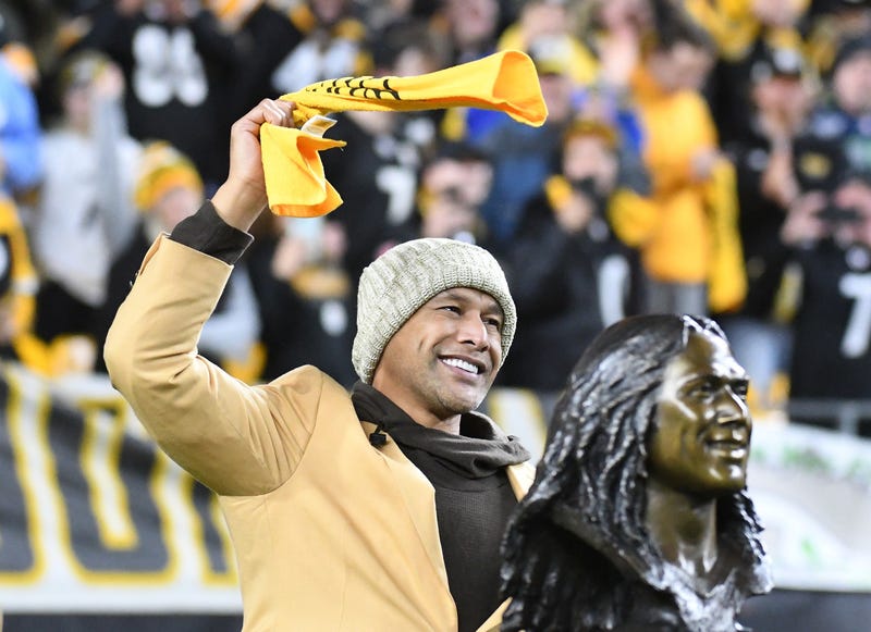 Troy Polamalu waving Terrible Towel with HOF bust