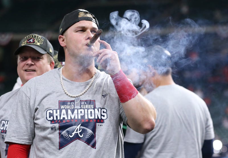 Atlanta Braves right fielder Joc Pederson smokes a cigar after defeating the Houston Astros in game six of the 2021 World Series at Minute Maid Park.