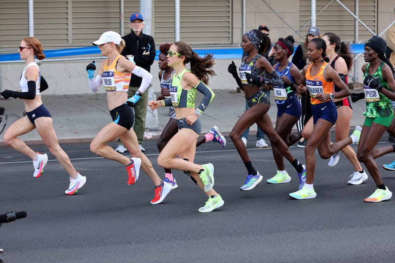 Molly Seidel (green top) was among only 12 runners in the lead pack at the 7-mile mark when they passed at 39:23. Sunday, November 7, 2021. 