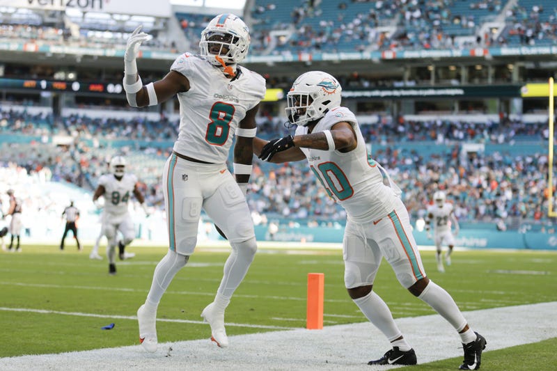 Miami Dolphins free safety Jevon Holland (8) celebrates with defensive back Nik Needham (40)