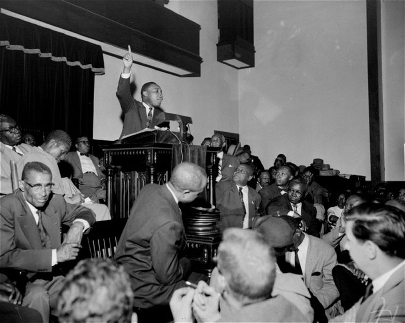 The Rev. Martin Luther King Jr. points skyward as he speaks at a mass meeting at Holt Street Baptist Church in Montgomery, Ala., during the Montgomery Bus Boycott