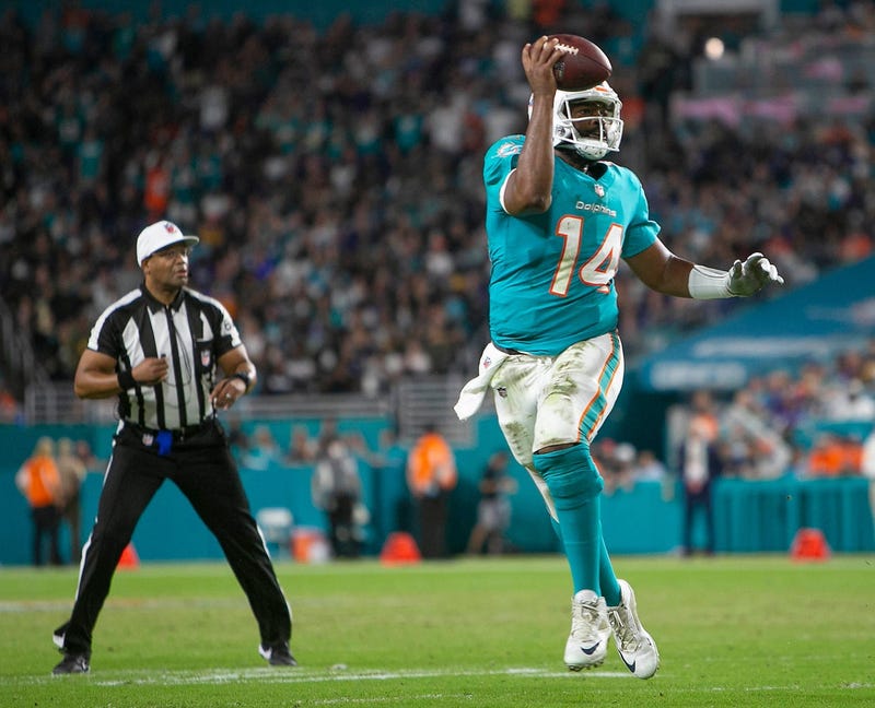 Miami Dolphins quarterback Jacoby Brissett (14), runs against the Baltimore Ravens