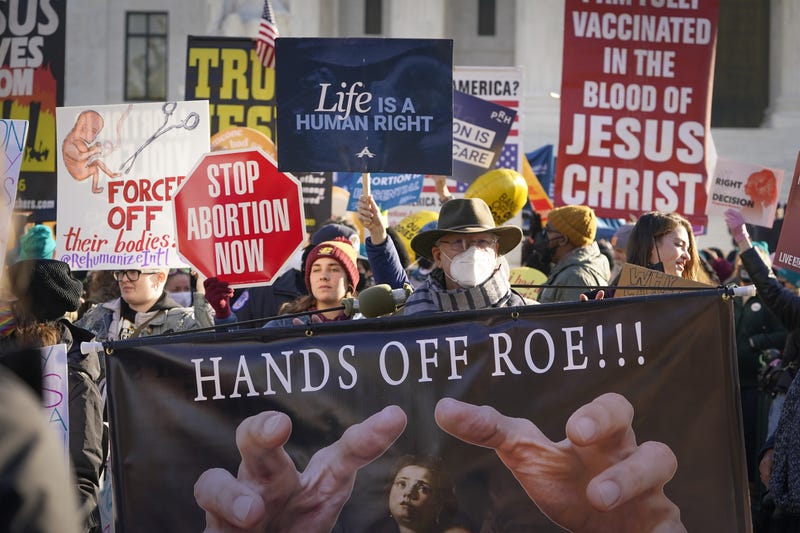 Demonstrators gather as the Supreme Court hears arguments in Dobbs v. Jackson Women's Health Organization