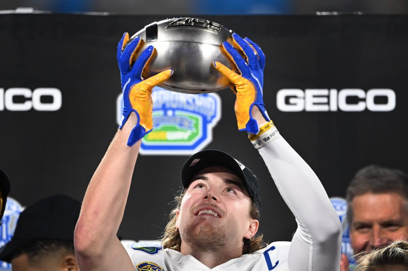 Kenny Pickett lifting up ACC Champ trophy