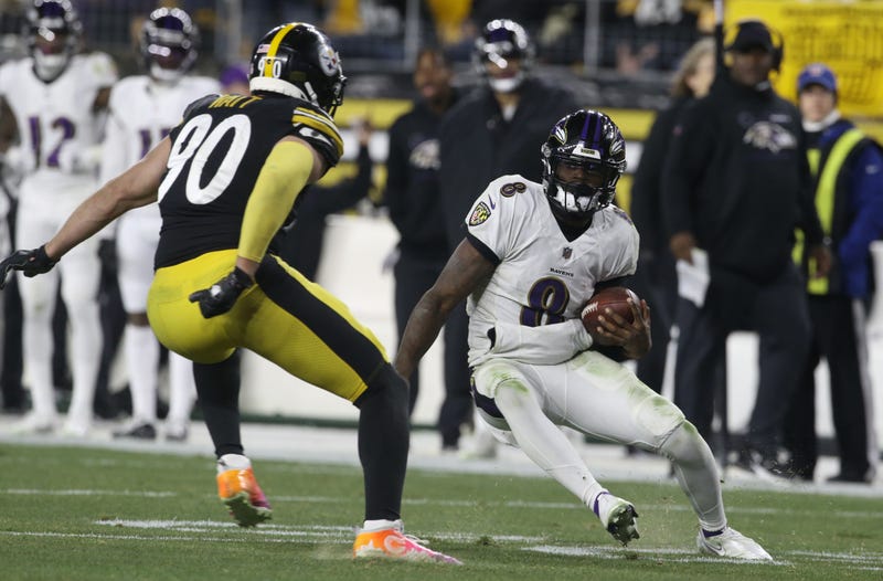 Ravens quarterback Lamar Jackson (8) runs the ball against Pittsburgh Steelers outside linebacker T.J. Watt (90) during the third quarter at Heinz Field.