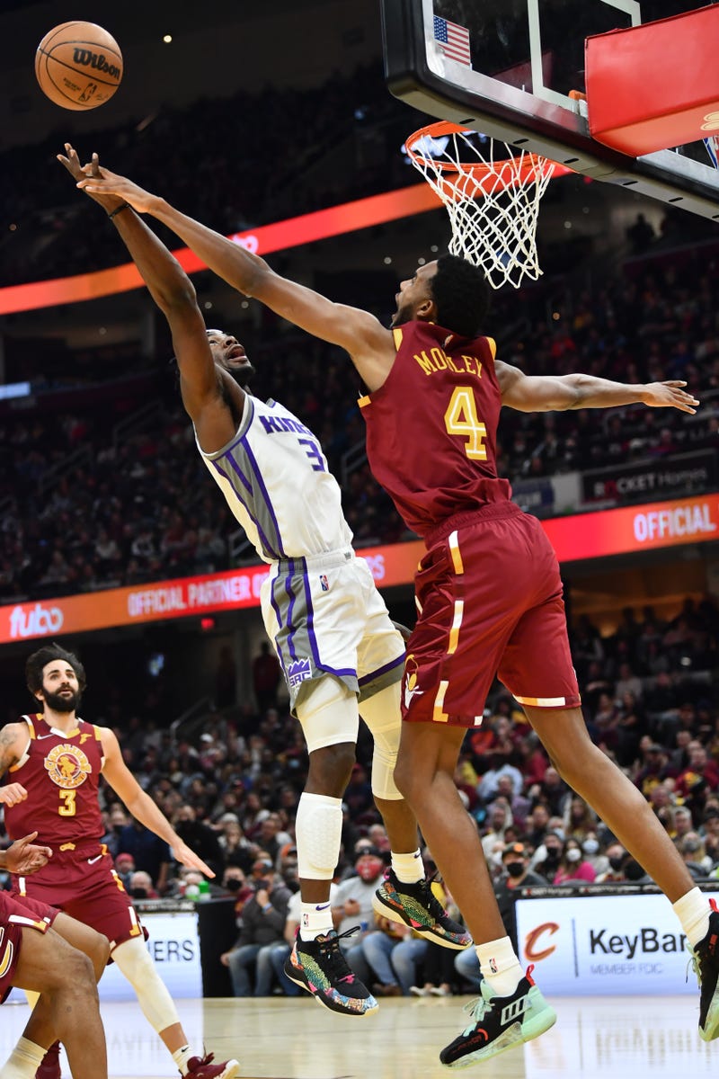 Dec 11, 2021; Cleveland, Ohio, USA; Cleveland Cavaliers forward Evan Mobley (4) defends the shot of Sacramento Kings guard Terence Davis (3) during the first half at Rocket Mortgage FieldHouse. 