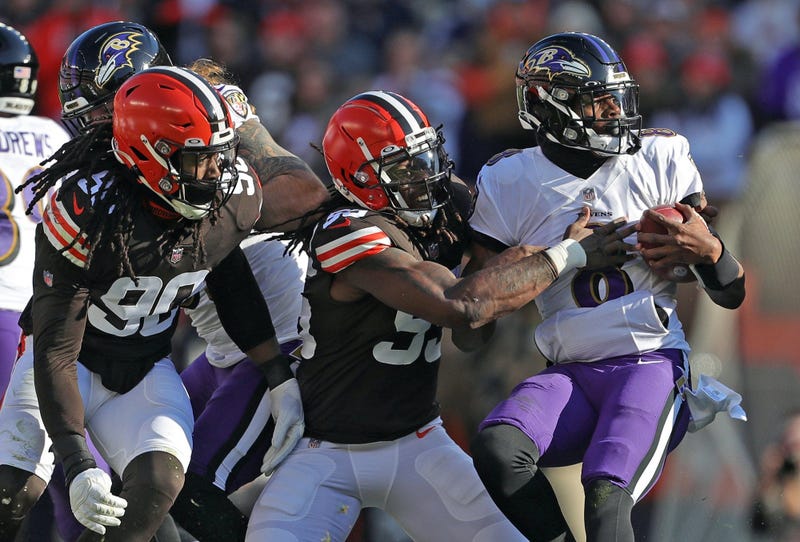 Lamar Jackson gets tackled by Cleveland defenders during the 2021 season