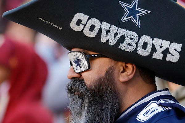 A Dallas Cowboys fan watches from the stands against the Washington Football Team 