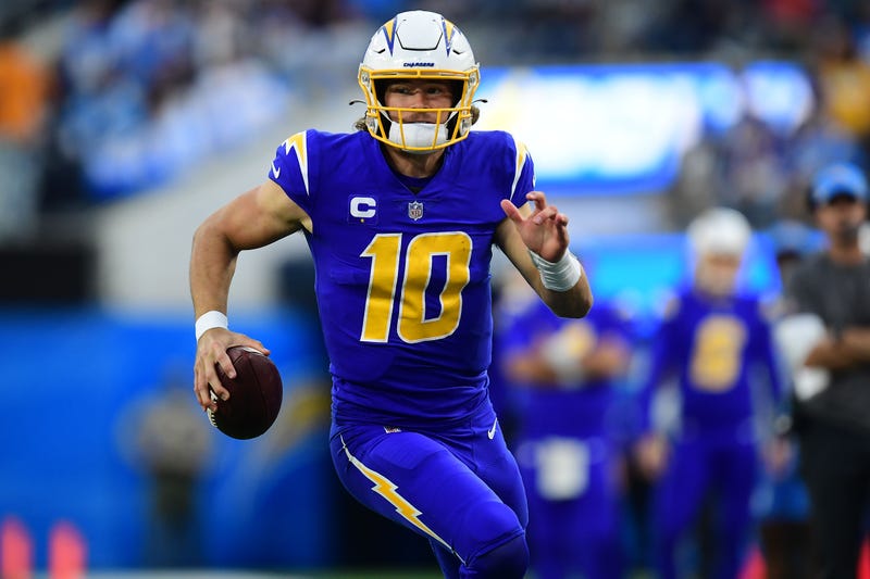 Justin Herbert models the Chargers color rush uniforms. 