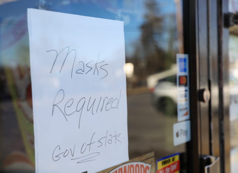 A sign on the door of a business reminds customers about Gov. Kathy Hochul's mask mandate on Dec. 13, 2021