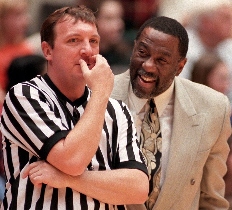  Coppin State head coach Ron \" Fang \" Mitchell bends an official's ear after call went against his team in game Saturday night in Ames versus Iowa State