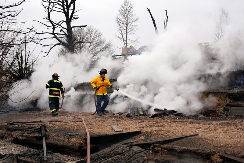 Firefighters from the Eaton Fire Department extinguish hot spots the morning after the wildfire in Louisville, Colo. on Dec 31, 2021. Usp News Colorado Wildfire Aftermath A Usa Co