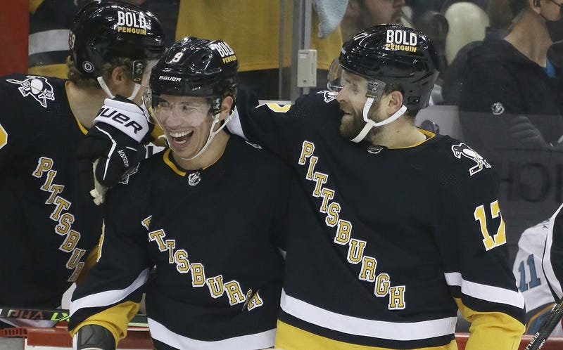 Bryan Rust and Evan Rodrigues hugging