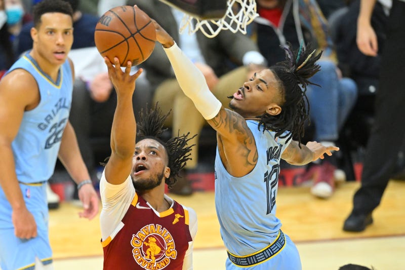 Jan 4, 2022; Cleveland, Ohio, USA; Memphis Grizzlies guard Ja Morant (12) blocks a shot by Cleveland Cavaliers guard Darius Garland (10) in the second quarter at Rocket Mortgage FieldHouse.