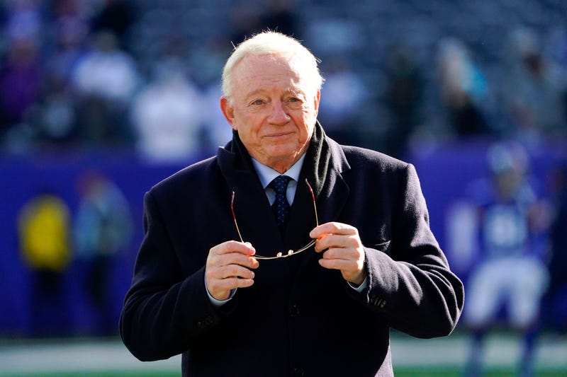 Dallas Cowboys owner and general manager Jerry Jones putting on sunglasses
