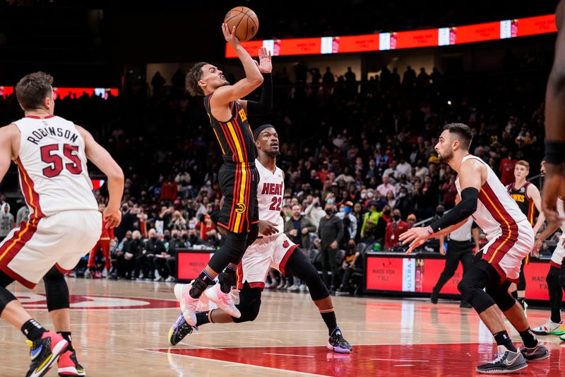 Atlanta Hawks guard Trae Young (11) shoots behind Miami Heat forward Jimmy Butler (22) during the second half at State Farm Arena.