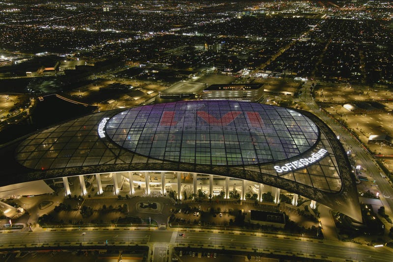 An undated aerial view of SoFi Stadium with Super Bowl LVI logo projected on the roof.