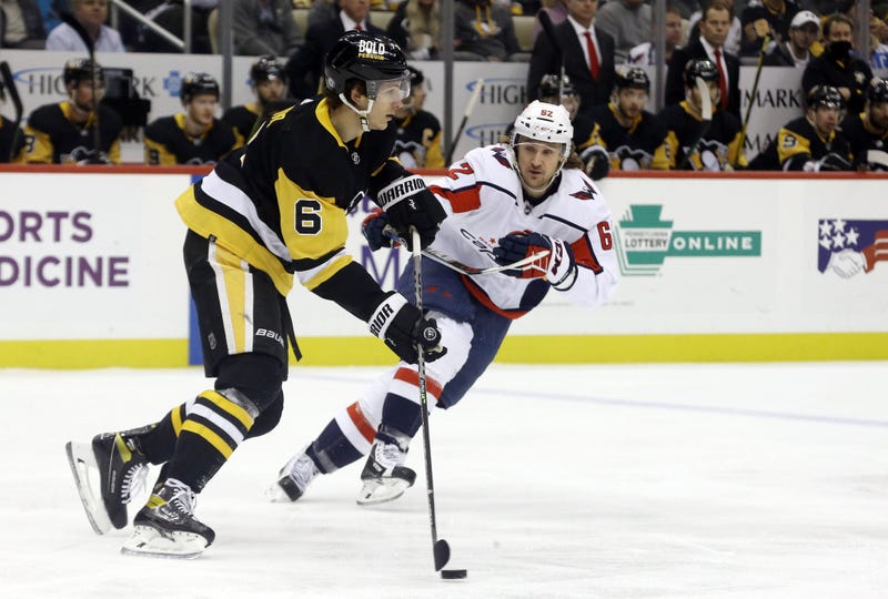 Pittsburgh Penguins defenseman John Marino (6) moves the puck against Washington Capitals left wing Carl Hagelin (62)