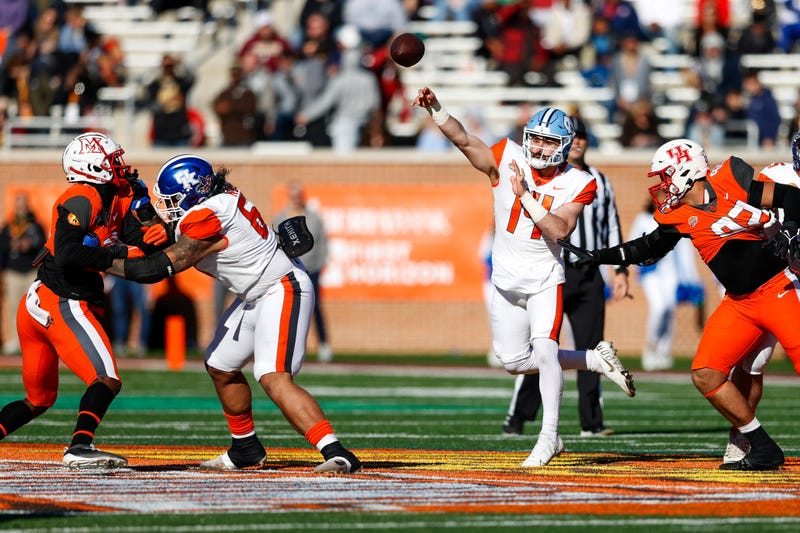 ; American squad quarterback Sam Howell of North Carolina (14) drops back to pass