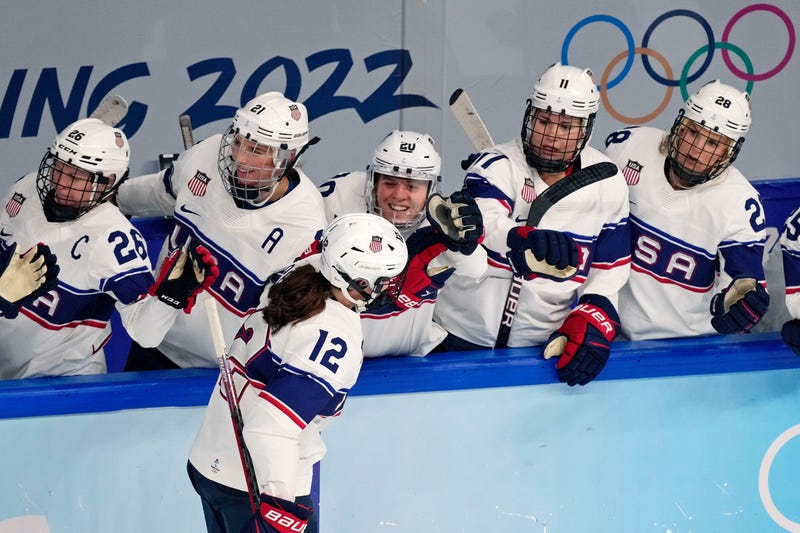 Team United States forward Kelly Pannek (12) is congratulated by the bench after scoring a goal against Switzerland during the first period during the Beijing 2022 Olympic Winter Games at Wukesong Sports Centre.