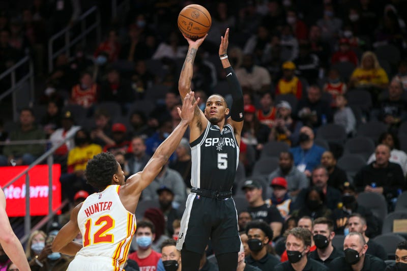 Feb 11, 2022; Atlanta, Georgia, USA; San Antonio Spurs guard Dejounte Murray (5) shoots over Atlanta Hawks forward De'Andre Hunter (12) in the first quarter at State Farm Arena. 
