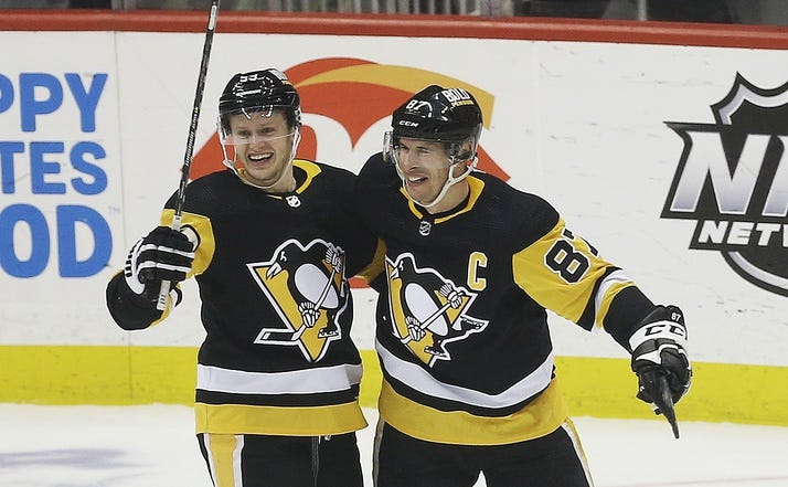 Pittsburgh Penguins center Sidney Crosby (87) reacts with left wing Jake Guentzel (59) after Crosby scored his 500th career NHL goal against the Philadelphia Flyers