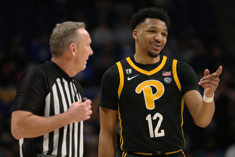 Pittsburgh Panthers guard Ithiel Horton (12) talks with referee Jamie Luckie (left)