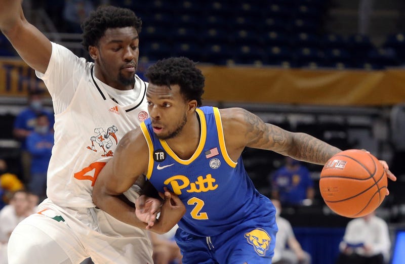 Pittsburgh Panthers guard Femi Odukale (2) dribbles the ball against Miami (Fl) Hurricanes guard Bensley Joseph (4) 