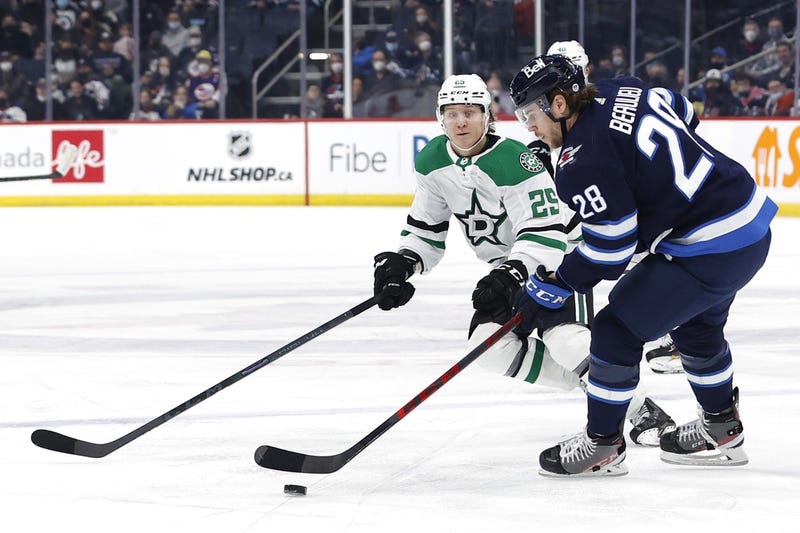 Winnipeg Jets defenseman Nathan Beaulieu (28) skates past Dallas Stars left wing Joel Kiviranta (25) in the first period at Canada Life Centre.