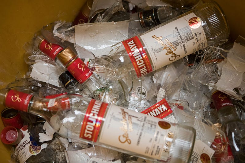 Bottles of Russian owned vodka Stolichnaya is smashed in a garbage can at FranksWine