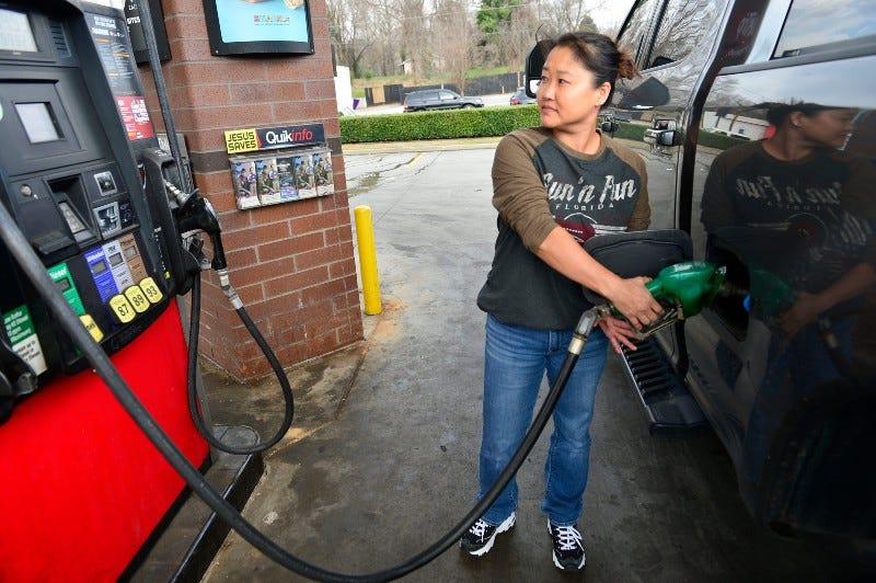 Woman fills her big pickup truck with diesel fuel.