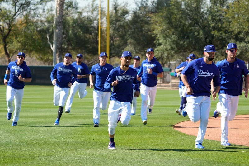FILE - Los Angeles Dodgers outfielders Mookie Betts (front, left) leads drills on March 15, 2022 during spring training camp at Camelback Ranch in Glendale, Ariz. 