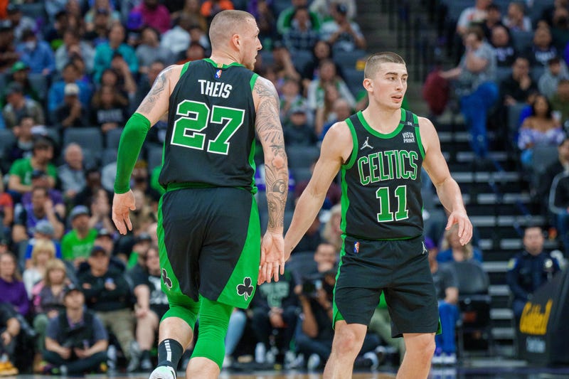 Payton Pritchard connects with Daniel Theis after knocking down a 3-pointer vs. the Kings