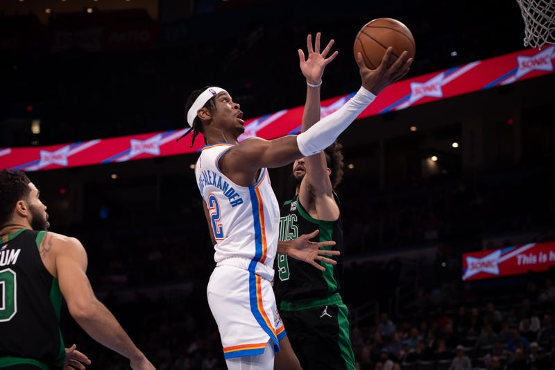 Mar 21, 2022; Oklahoma City, Oklahoma, USA; Oklahoma City Thunder guard Shai Gilgeous-Alexander (2) shoots the ball while defended by Boston Celtics guard Derrick White (9) during the first half at Paycom Center.