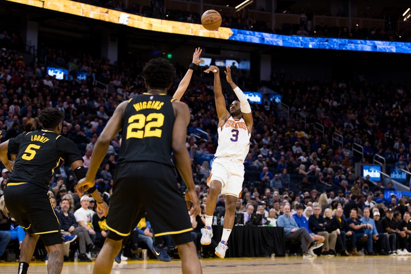 Chris Paul shoots over Warriors defenders during a game on March 30th